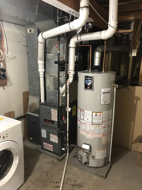 Basement with furnace, water heater and overhead piping